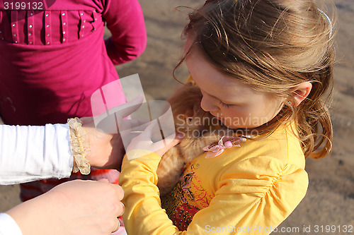 Image of little girl with little red kitten