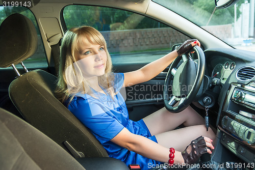 Image of Young attractive woman driving her car