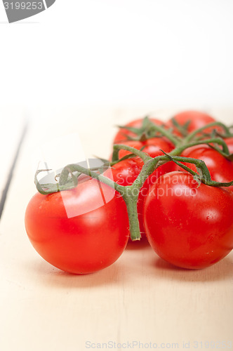 Image of fresh cherry tomatoes on a cluster