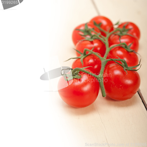 Image of fresh cherry tomatoes on a cluster