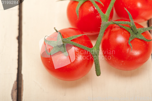 Image of fresh cherry tomatoes on a cluster