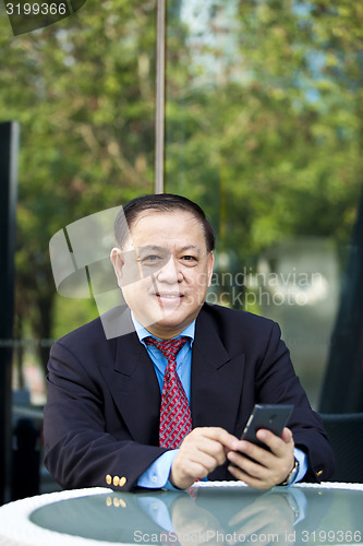 Image of Asian businessman using smart phone