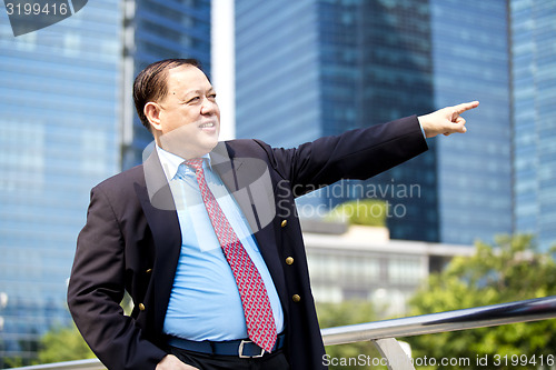 Image of Asian businessman pointing at a direction