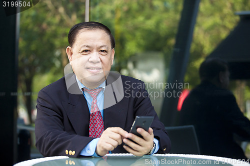 Image of Asian businessman using smart phone