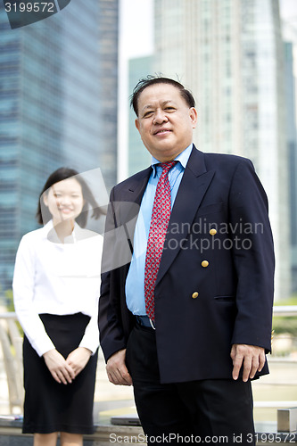 Image of Asian businessman and young female executive smiling portrait