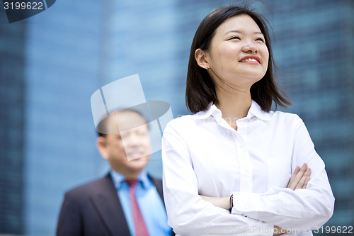 Image of Asian businessman and young female executive smiling portrait