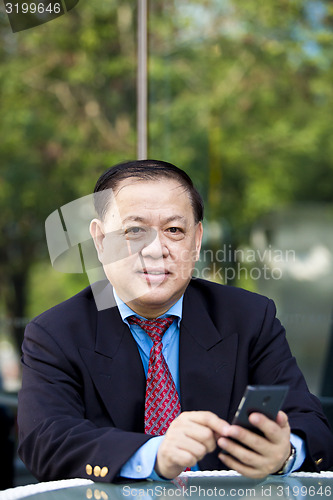 Image of Asian businessman using smart phone