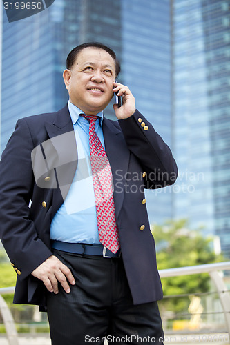 Image of Asian businessman talking on smart phone