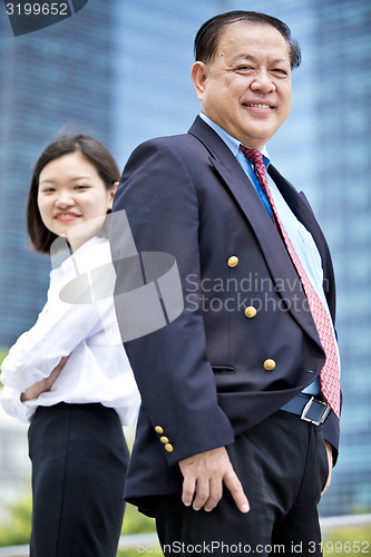 Image of Asian businessman and young female executive smiling portrait