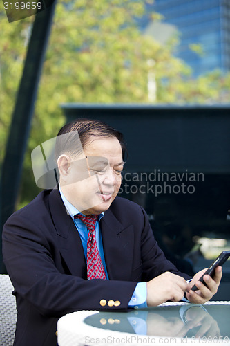 Image of Asian businessman using smart phone