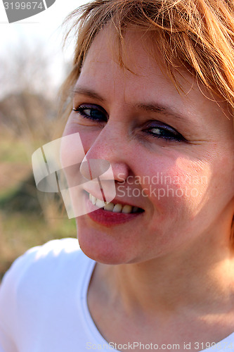 Image of blue-eyed sympathetic girl looking at the sky