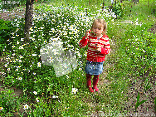 Image of little girl swelling soap bubbles