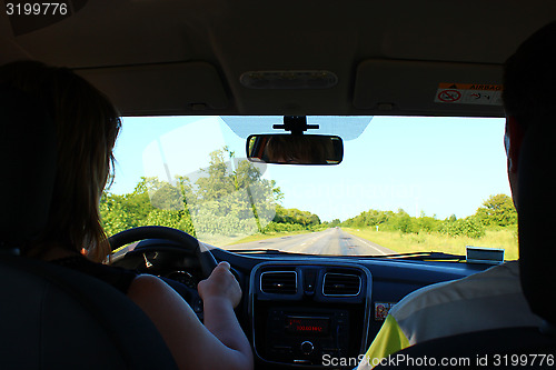 Image of Young woman driving the car