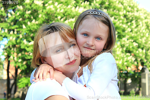 Image of mother and daughter embrace one another