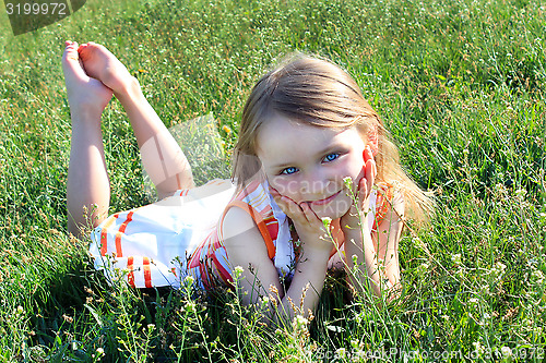 Image of little girl lying on the grass