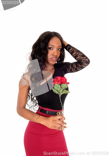 Image of Black woman holding red rose. 