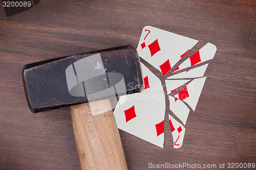 Image of Hammer with a broken card, seven of diamonds