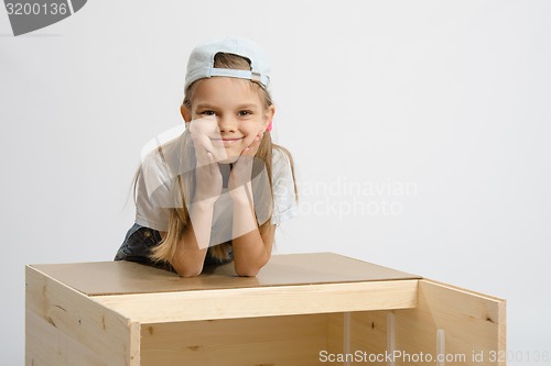 Image of Portrait a girl leaning on back cover of chest