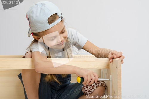 Image of girl having fun twists screw