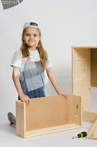 Image of Girl collects furniture