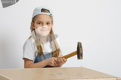 Image of child hammer a nail into the back of chest