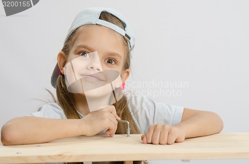 Image of Girl likes to twist the screw with an Allen key