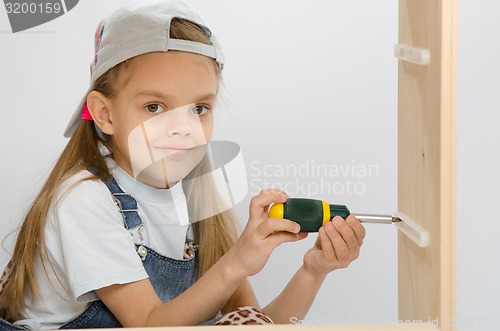 Image of Child spins mounting boxes, collecting cabinet