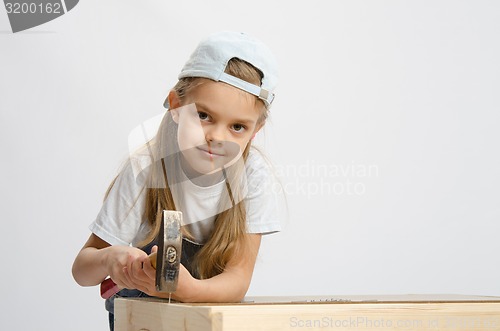 Image of Child labor in classroom hammer nails with a hammer