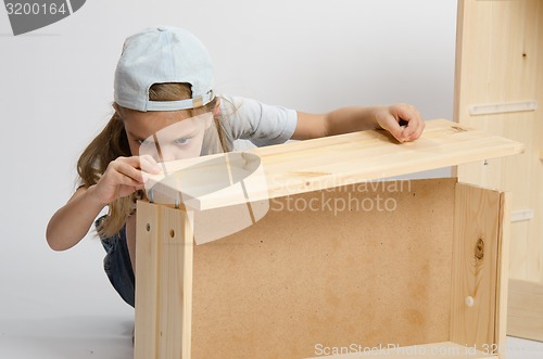 Image of Girl collects facade box