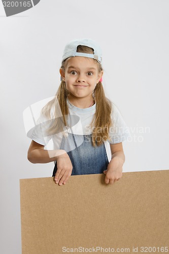 Image of Girl holding a wooden board