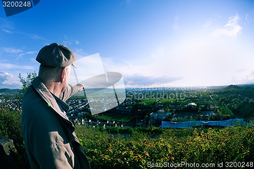 Image of elderly man in nature at sunset