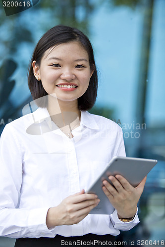 Image of Asian young female executive using tablet