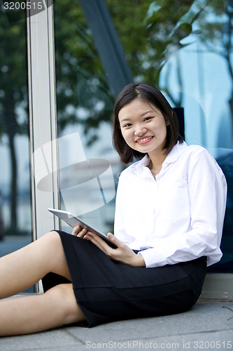 Image of Asian young female executive using tablet