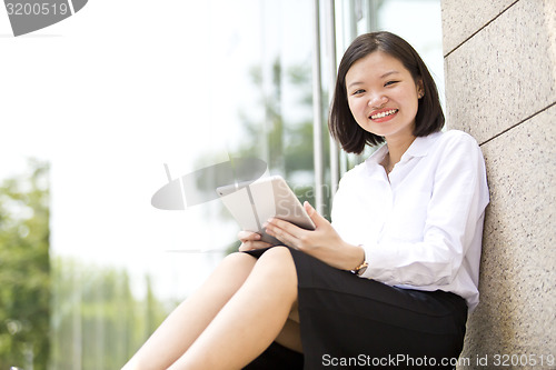 Image of Asian young female executive using tablet