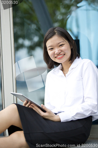 Image of Asian young female executive using tablet