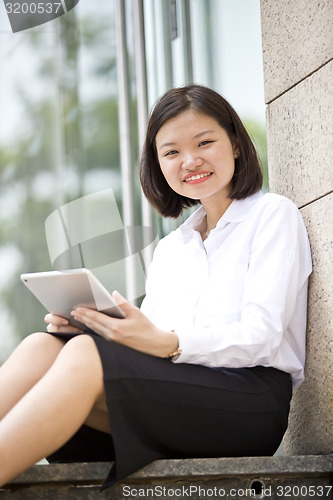 Image of Asian young female executive using tablet
