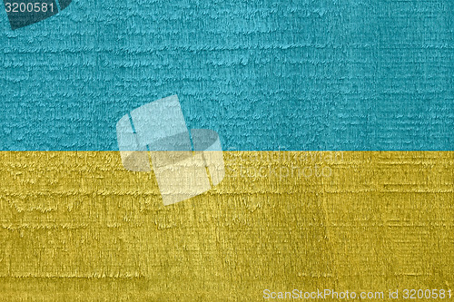 Image of Flag of Ukraine on old dried wood texture