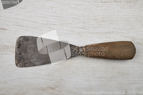 Image of Putty knife on wood