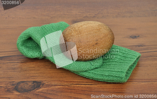 Image of Darning egg with hand-knitted sock