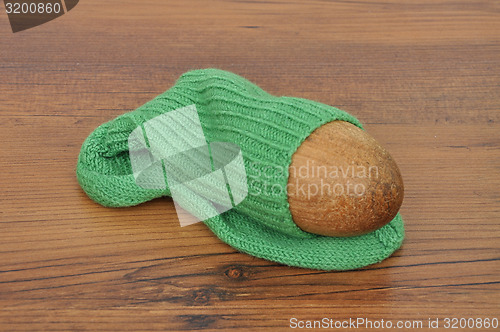 Image of Darning egg with hand-knitted sock