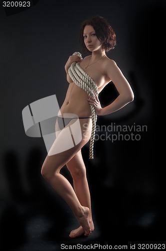 Image of topless woman body covering by rope