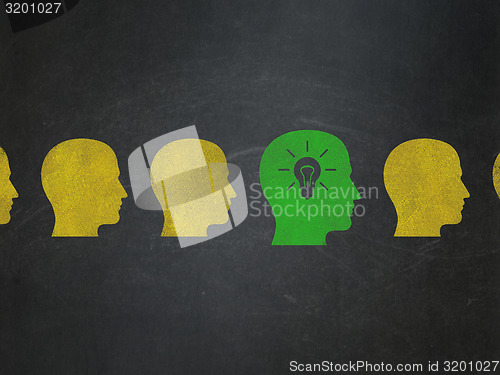 Image of Business concept: green head with light bulb icon on School Board background