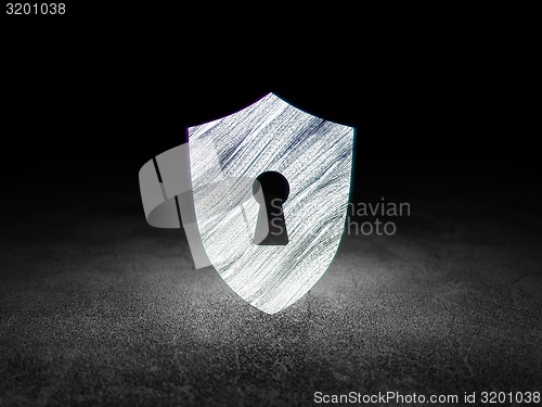 Image of Safety concept: Shield With Keyhole in grunge dark room