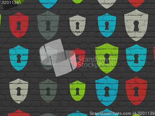 Image of Safety concept: multicolor Shield With Keyhole icons on wall background