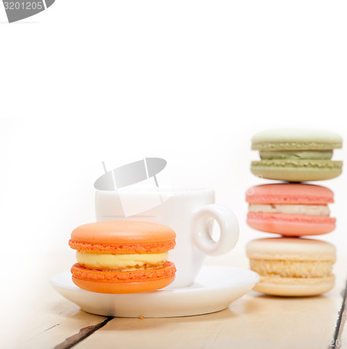 Image of colorful macaroons with espresso coffee 
