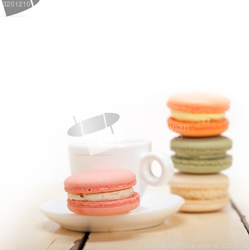 Image of colorful macaroons with espresso coffee 