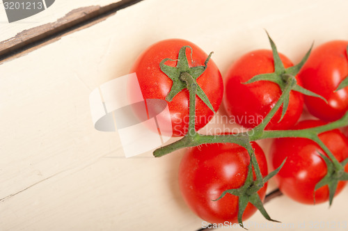 Image of fresh cherry tomatoes on a cluster