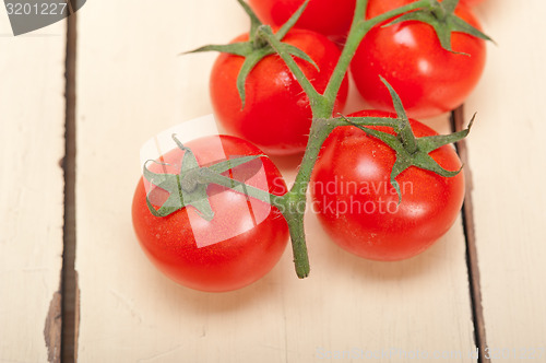 Image of fresh cherry tomatoes on a cluster