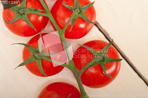 Image of fresh cherry tomatoes on a cluster