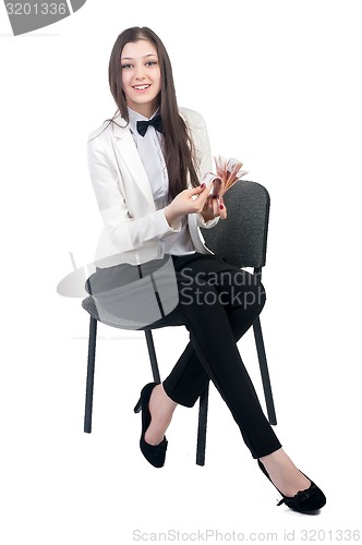 Image of Pretty business lady with roubles sits on chair